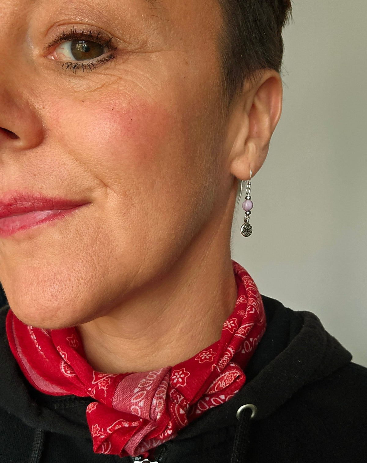Flower earring worn with a sterling silver ear hook