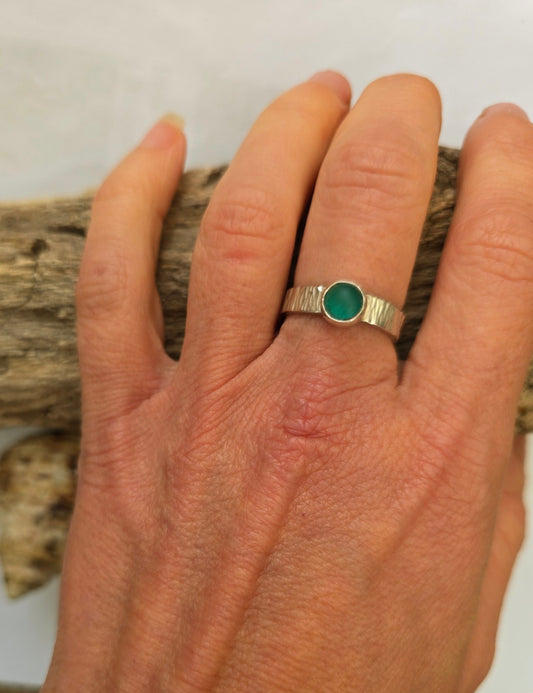 Green sea glass ring in recycled sterling silver with a textured adjustable band